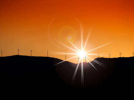 Wind turbines on mountaintop at sunsetの写真素材
