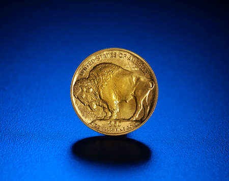 Gold American Buffalo $ 50. 1 oz. coin, on blueの写真素材