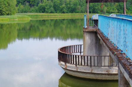 metal dam damming water on the riverの写真素材