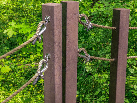 Climbing equipment on a wooden fence in the forest, close-up