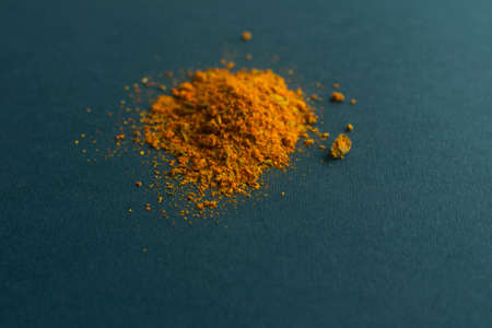 handful of bright spices on a dark backgroundの写真素材