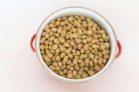 Top view mulberries in pot on white background. horizontalの写真素材