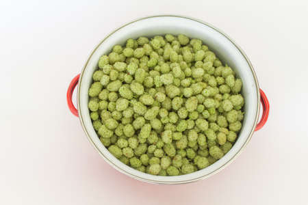 Top view mulberries in pot on white background. horizontal