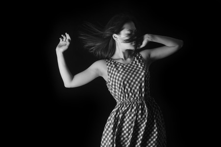 photo of the girl in a summer dress on a black backgroundの写真素材