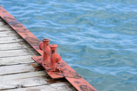 Old pier and blue water in summerの写真素材