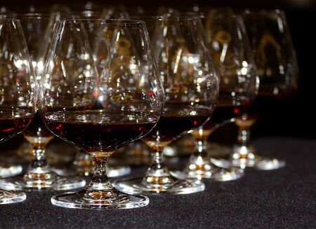 Glasses of cognac on a gray table close upの写真素材
