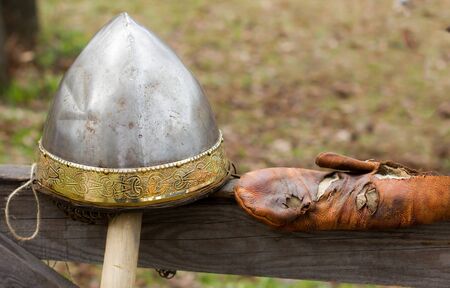 Antique metal knight's helmet with a gold borderの写真素材