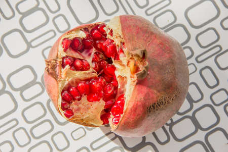 Red ripe open pomegranate with juicy fruits close-up detailの写真素材