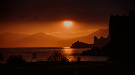 beautiful sunset on the sea against the background of mountains. detailの写真素材