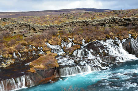 Hraunfossar lava waterfalls falling with blue waterの写真素材