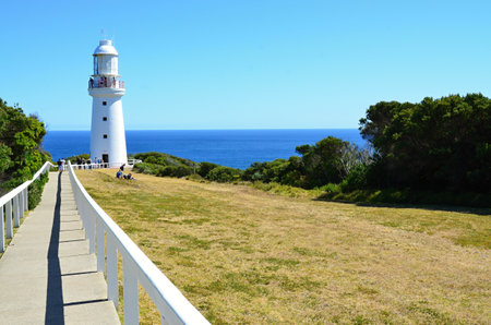 A white lighthouse on the rocky coast of South Australia near Melbourneの写真素材