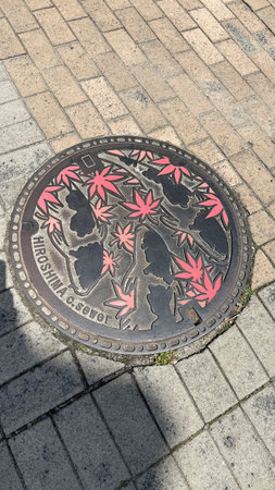 Manhole cover on the street in the city of Osaka Japanの写真素材