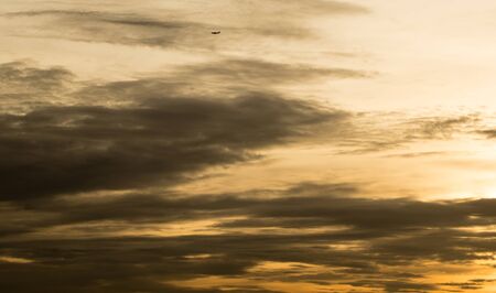 Sunset over Bangkok - Golden sky with planeの写真素材