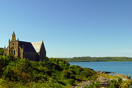 Church on the shore of a lake in Scotlandの写真素材