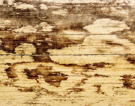 Weathered old wood peel painted pale yellow.の写真素材