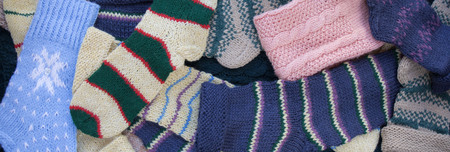 Colorful knitted rough woolen socks background. Winter background.の写真素材