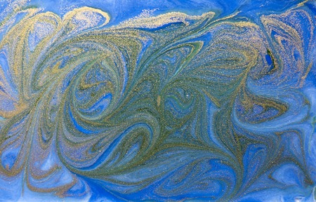 Blue and golden liquid texture, watercolor hand drawn marbling illustration, abstract background.の写真素材