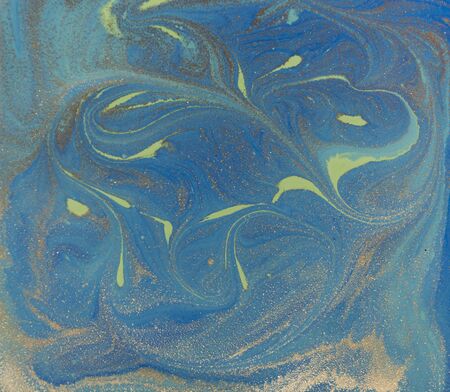 Blue and golden liquid texture, watercolor hand drawn marbling illustration, abstract background.の写真素材