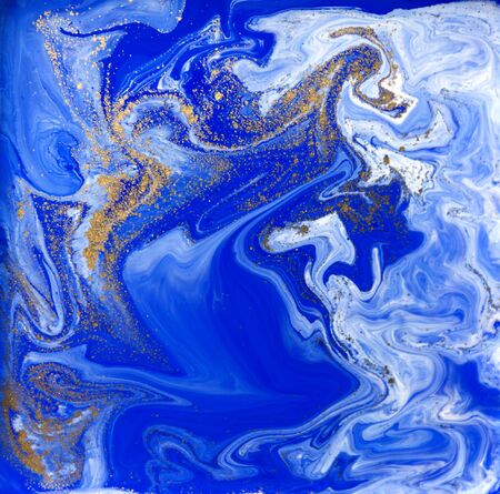 Blue and gold liquid texture. Hand drawn marbling background. Ink marble abstract patternの写真素材