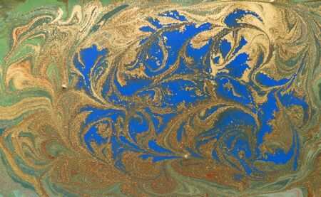 Blue and gold liquid texture. Hand drawn marbling background. Ink marble abstract patternの写真素材