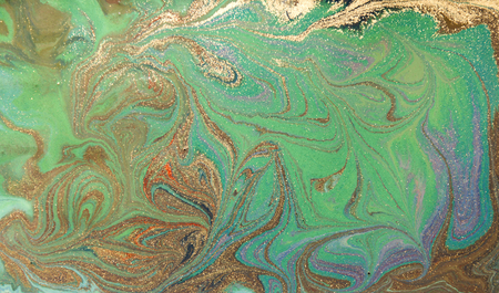 Green and golden liquid texture. Hand drawn marbling background. Ink marble abstract patternの写真素材