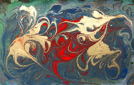 Red and gold liquid texture. Hand drawn marbling background. Ink marble abstract patternの写真素材