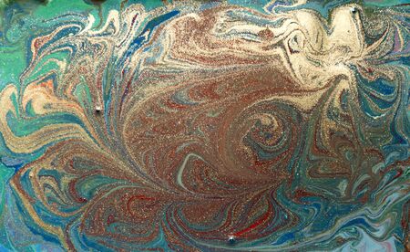 Red and gold liquid texture. Hand drawn marbling background. Ink marble abstract patternの写真素材