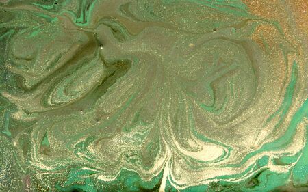 Green and golden liquid texture. Hand drawn marbling background. Ink marble abstract patternの写真素材