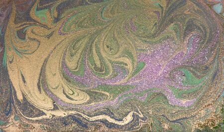 Green, purple and golden liquid texture. Hand drawn marbling background. Ink marble abstract patternの写真素材