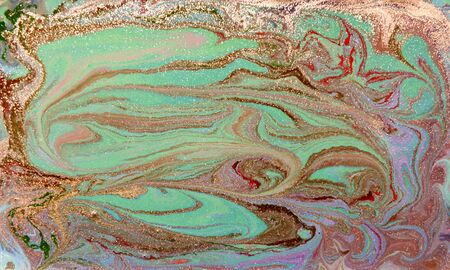 Green and golden liquid texture. Hand drawn marbling background. Ink marble abstract patternの写真素材