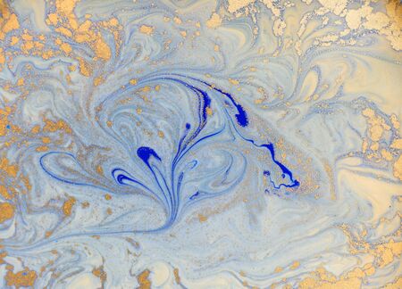 Blue and golden liquid texture. Watercolor hand drawn marbling illustration. Ink marble background.の写真素材