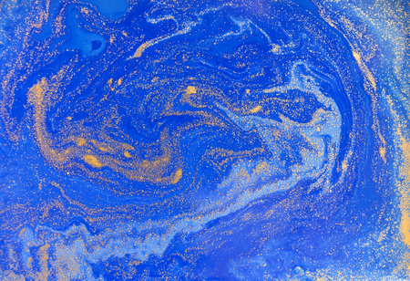 Blue and golden liquid texture. Watercolor hand drawn marbling illustration. Ink marble background.の写真素材
