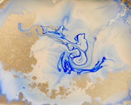 Blue and golden liquid texture. Watercolor hand drawn marbling illustration. Ink marble background.の写真素材