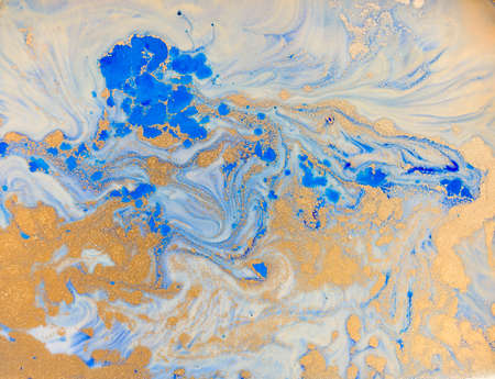 Blue and golden liquid texture. Watercolor hand drawn marbling illustration. Ink marble background.の写真素材