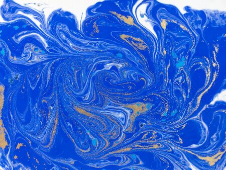 Blue and golden liquid texture. Watercolor hand drawn marbling illustration. Ink marble background.の写真素材