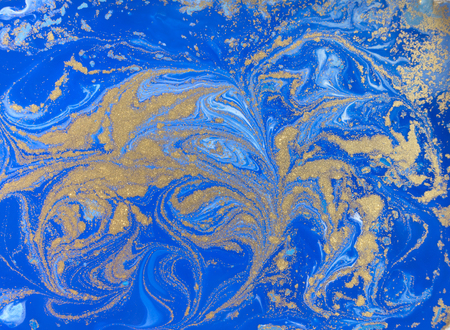 Blue and golden liquid texture. Watercolor hand drawn marbling illustration. Ink marble background.の写真素材