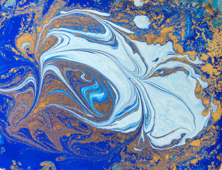 Blue and golden liquid texture. Watercolor hand drawn marbling illustration. Ink marble background.の写真素材