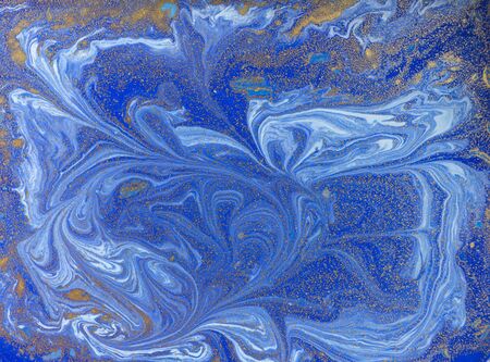 Blue and golden liquid texture. Watercolor hand drawn marbling illustration. Ink marble background.の写真素材