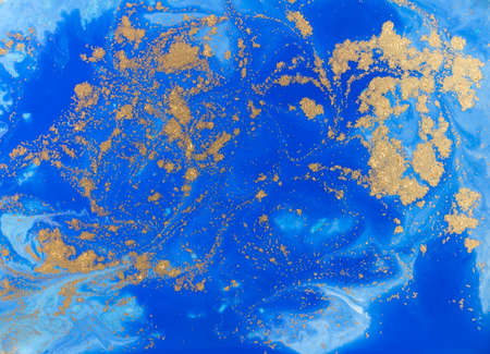 Blue and golden liquid texture. Watercolor hand drawn marbling illustration. Ink marble background.の写真素材