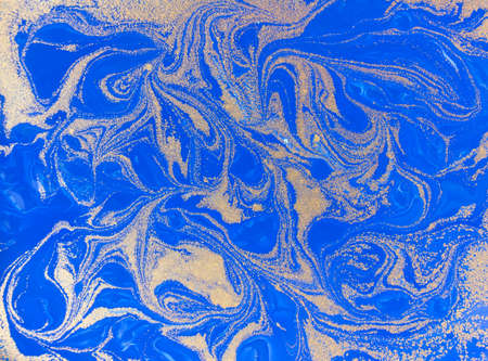 Blue and golden liquid texture. Watercolor hand drawn marbling illustration. Ink marble background.の写真素材