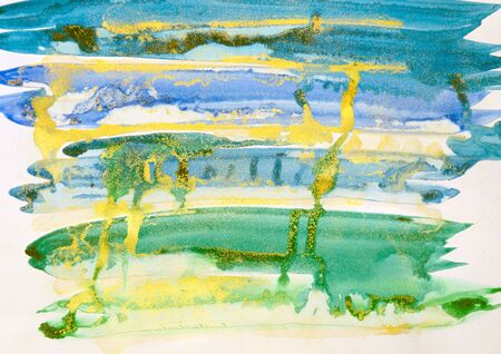 Watercolor background painting on white paper. Blue, green and golden abstract texture. Color smudges surface.の写真素材