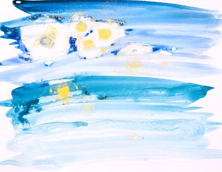 Watercolor background painting on white paper. Blue, green and golden abstract texture. Color smudges surface.の写真素材