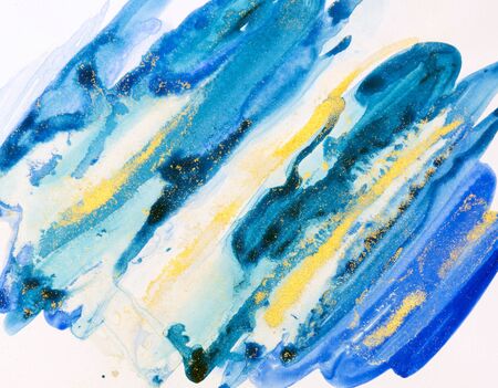 Watercolor background painting on white paper. Blue, green and golden abstract texture. Color smudges surface.の写真素材