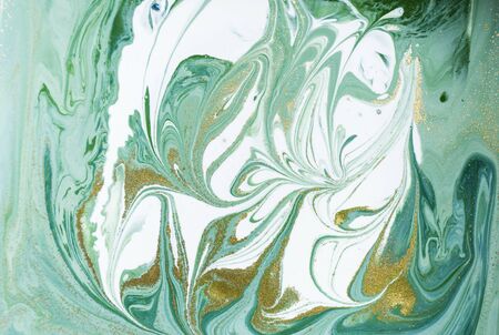 Marbled green and golden abstract background. Liquid marble patternの写真素材