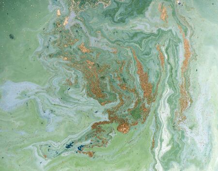 Marbled green and golden abstract background. Liquid marble pattern.の写真素材