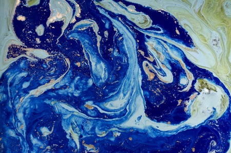 Marbled green and blue abstract background with golden sequins. Liquid marble ink pattern.