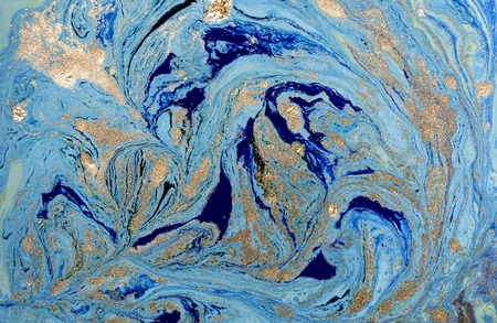 Marbled blue abstract background with golden sequins. Liquid marble ink patternの写真素材