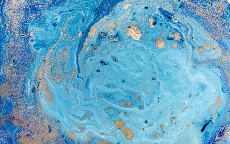 Marbled blue abstract background with golden sequins. Liquid marble ink pattern.の写真素材