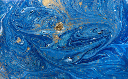 Marbled blue abstract background with golden sequins. Liquid marble ink pattern.の写真素材