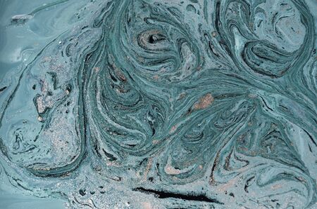 Marbled blue abstract background with golden sequins. Liquid marble ink patternの写真素材